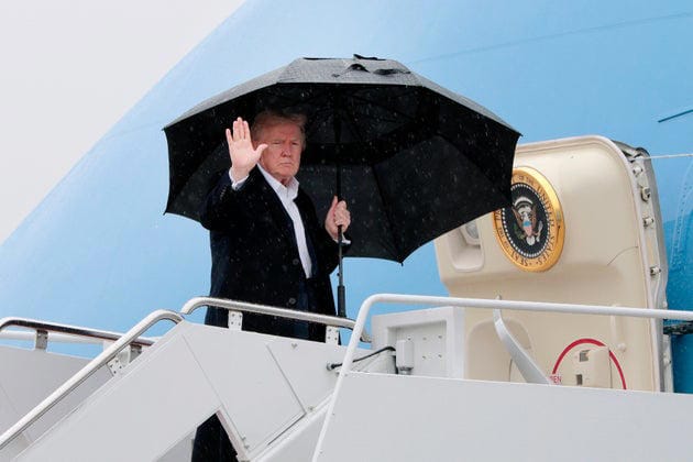 President Donald Trump waves as he boards Air Force One on April 11, 2025, at Joint Base Andrews, Maryland.