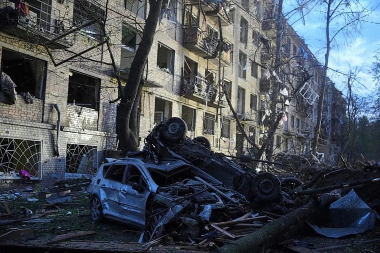 Damaged cars lie in a yard with other debris after a Russian ballistic missile attack in Kyiv, Ukraine, Thursday, April 24, 2025.