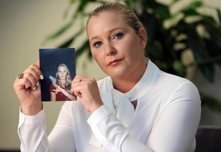 Virginia Roberts Giuffre holds a photo of herself during her teen years when she says she was abused by Jeffrey Epstein, Ghislaine Maxwell and Prince Andrew, among others.