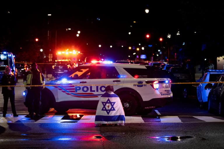 A bystander prays near the Capital Jewish Museum in Washington D.C., May 21, 2025, after two Israeli Embassy staff members were fatally shot after attending an event at the museum earlier in the evening.